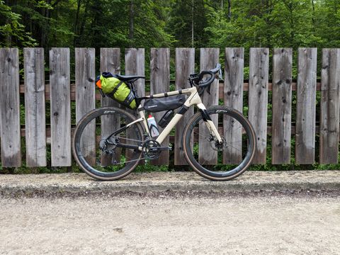 My Topstone with saddle bag, leaning against a fence on a bridge on the old Postalm road.